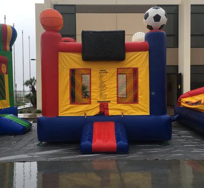 Colorful inflatable bounce house featuring a soccer ball and basketball design, perfect for outdoor play and fun.