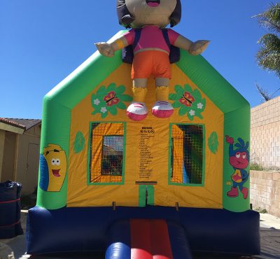 A colorful bounce house featuring Dora the Explorer prominently displayed on top.