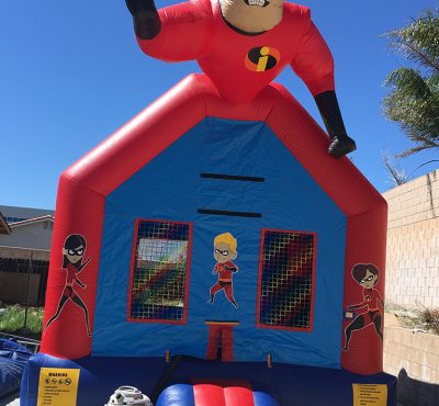 A colorful bounce house themed after The Incredibles, featuring characters and vibrant designs for children's play.